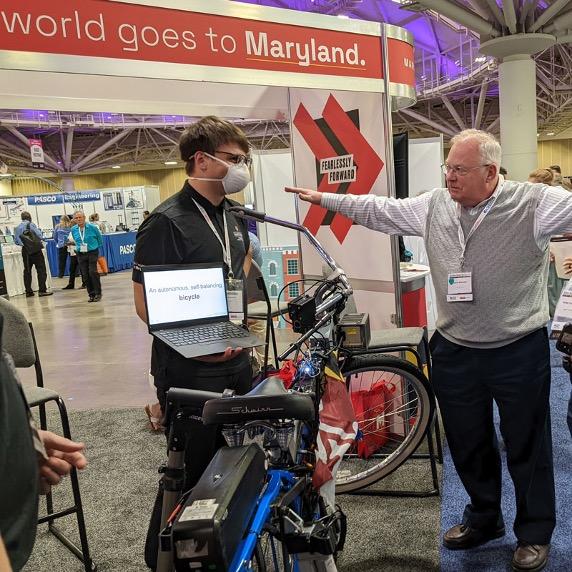 Mechanical engineering student demonstrating their self-balancing electric bicycle.