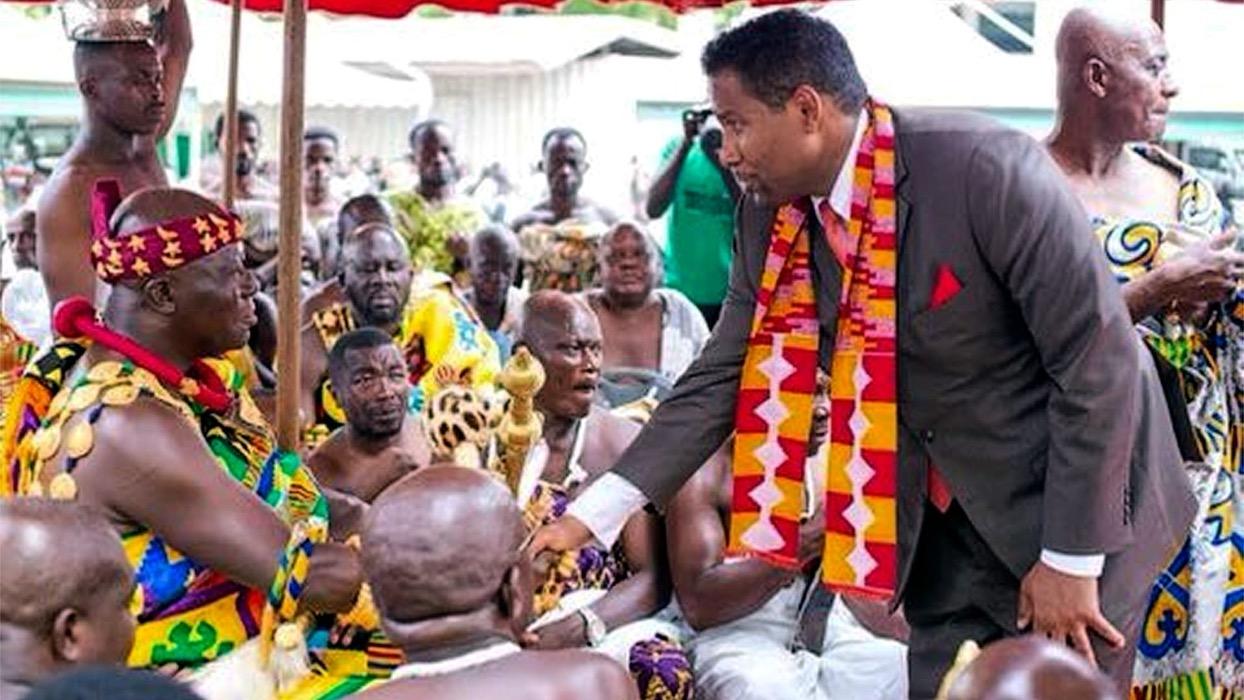 Pines shake hands with Osei Tutu II, monarch of the Asante Empire, who sits amid his court at Manhyia Palace in Kumasi