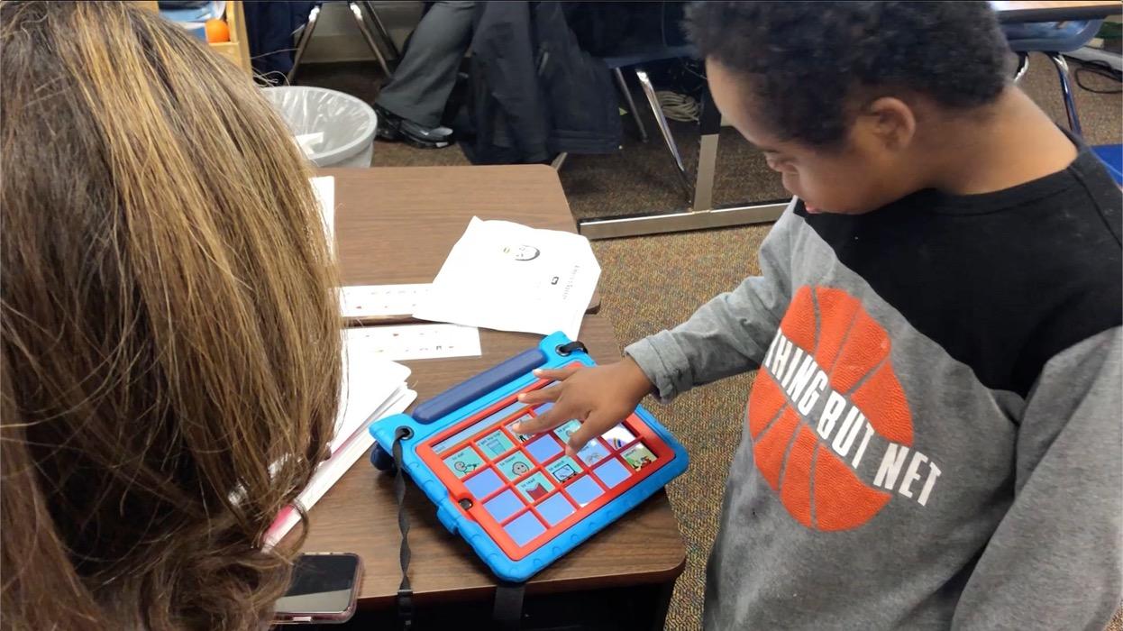 A special needs student in a class trying one of the e4usa students' project