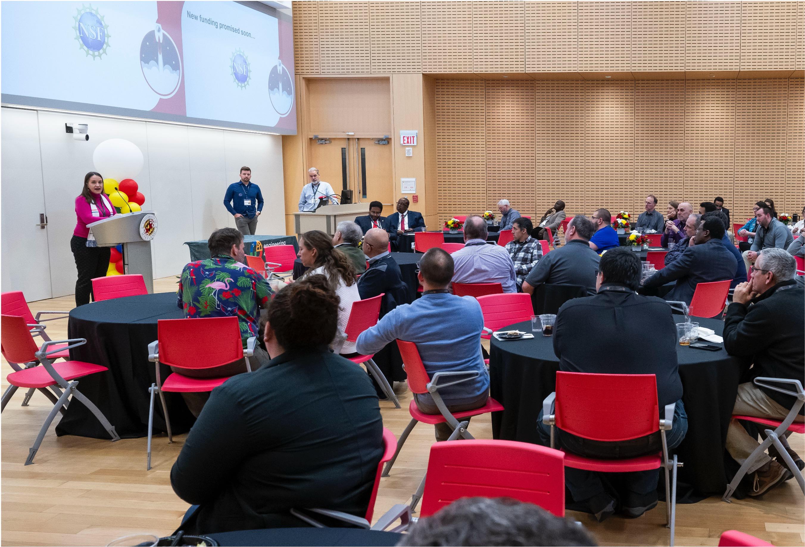 large group attending a conference session in a large event space